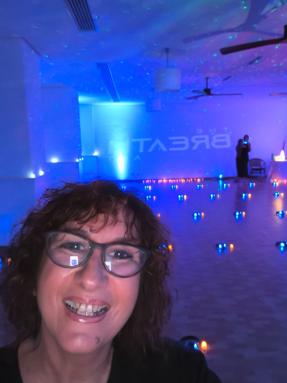 Facilitadora sonriendo en la sala preparada para el evento